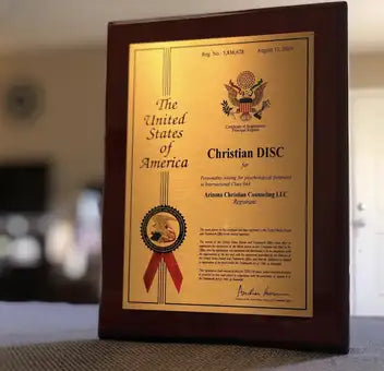 A dark brown wooden-framed certificate with a gold-colored plaque featuring embossed text and an official seal.