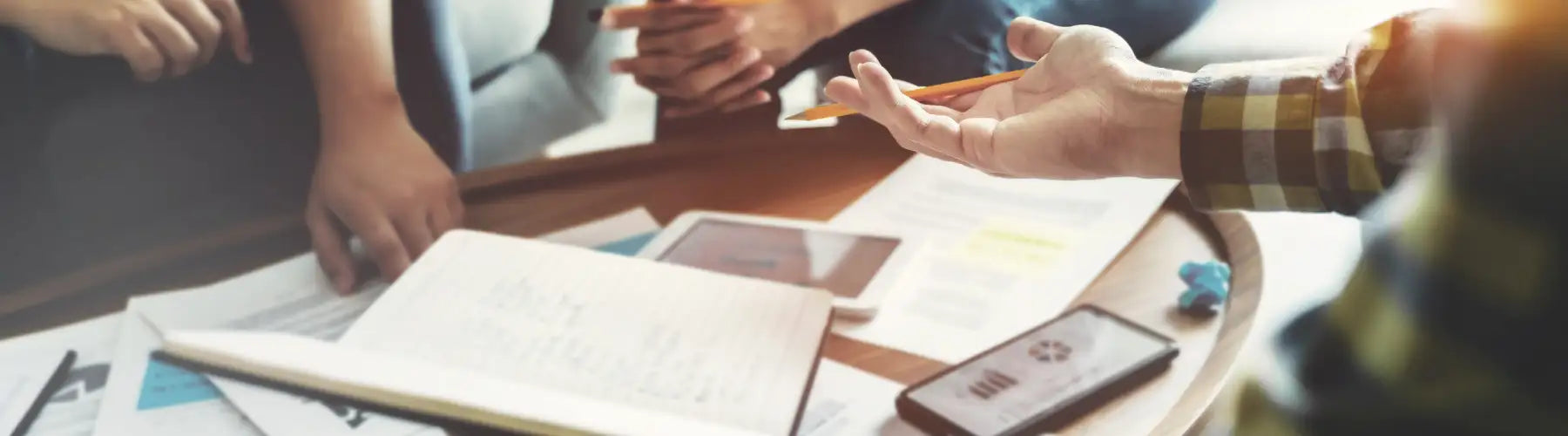 A smartphone with a black case and screen displaying a graph, resting on a wooden table.