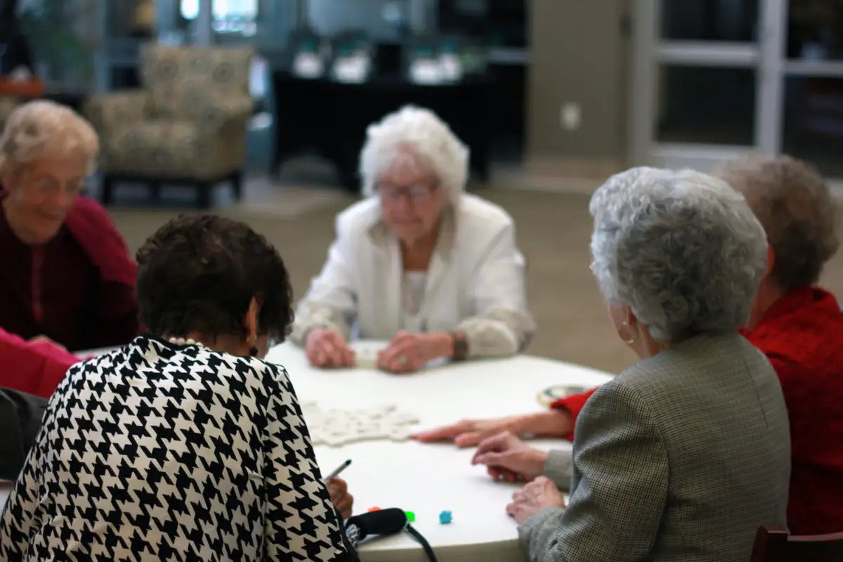 White table with a smooth, slightly reflective surface and faintly visible grid lines from the game being played on it.